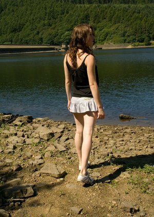 18 year old girl Katie Lewis stands naked after undressing in her bedroom